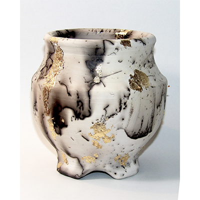 A black and white ceramic pot with gold leaf details.