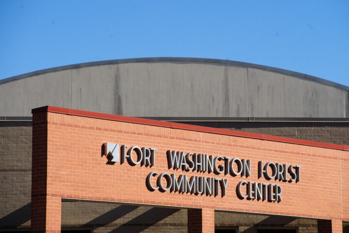 Close-up view of the words FORT WASHINGTON FOREST COMMUNITY CENTER on the red brick facade of a building.